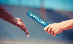Baton with Patients First written on it being passed from one runner's hand to anothers.