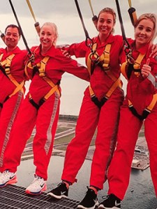 Caroline showing leadership with three other people participating in CN Tower Edge Walk